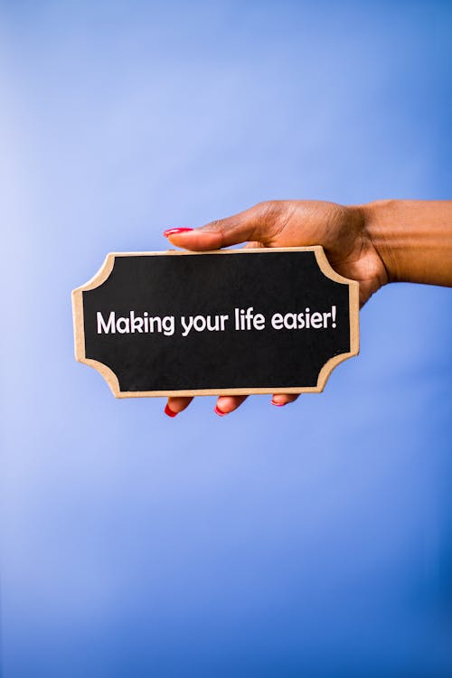 Free A Person Holding Black and Brown Board Stock Photo